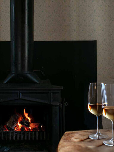 Roaring fireplace in cozy room in Mendocino, CA
