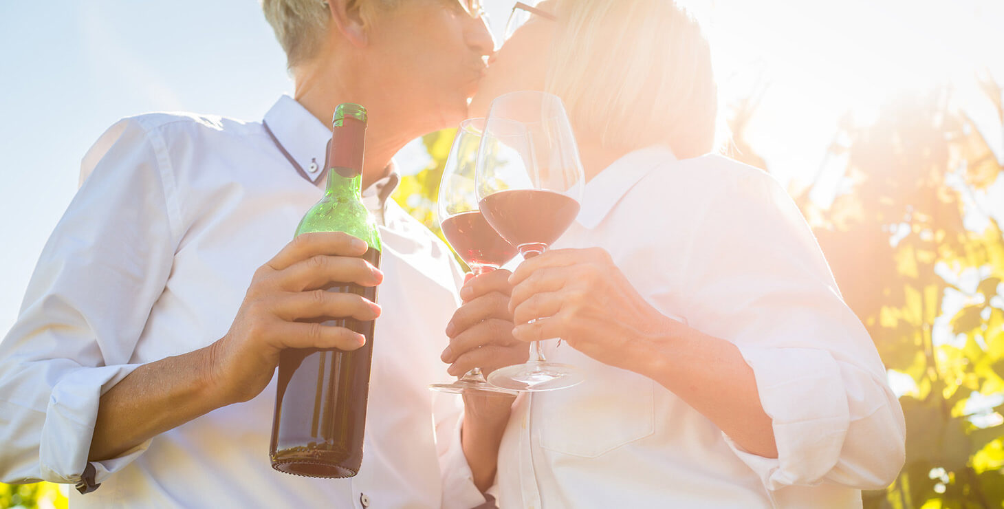 Couple kissing with wine